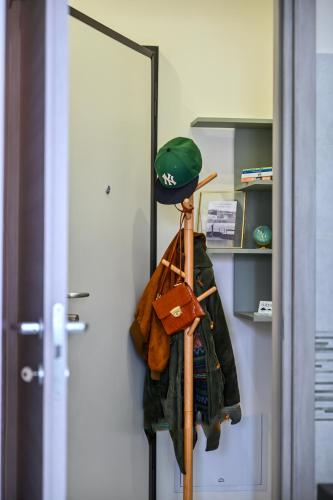 a room with a mirror and a hat and clothes at Solema Lake Como in Bellano