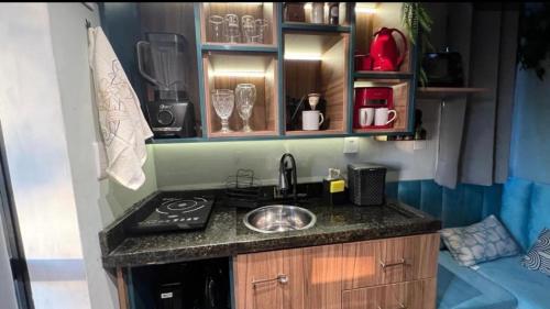 a small kitchen with a sink and a stove at Minicasa Brasileira in Sorocaba