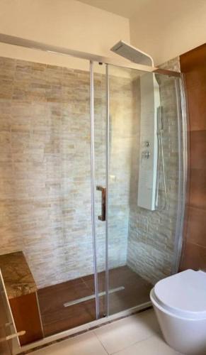 a bathroom with a shower and a toilet at Mediterraneum in Sannicola