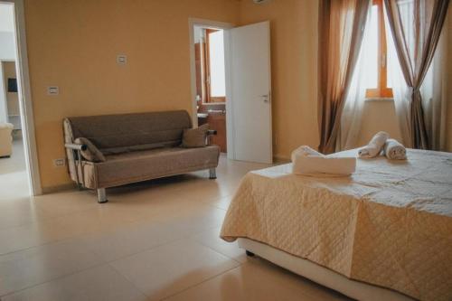 a living room with a bed and a couch at Mediterraneum in Sannicola