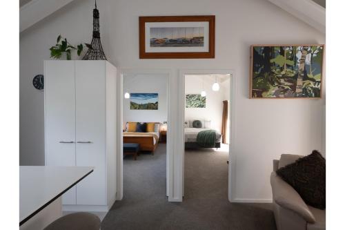 a living room with a bedroom and a bed at Tawa Retreat - Wellington Holiday Home in Wellington