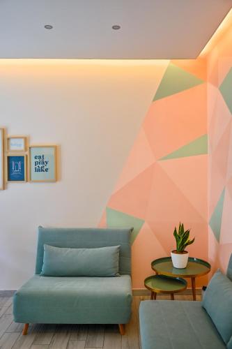a living room with a couch and a geometric wall at Solema Lake Como in Bellano