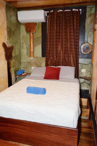 a bedroom with a bed with a blue tray on it at Apartotel VILLA ALTA TAMARINDO in Tamarindo