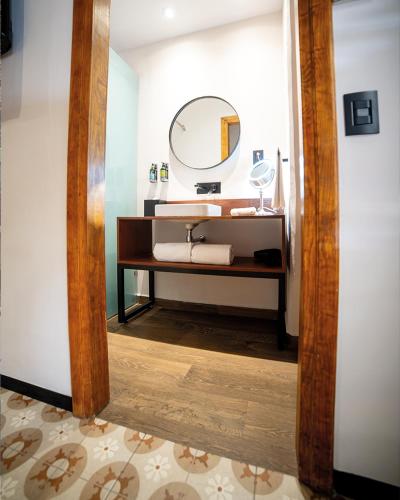 a bathroom with a sink and a mirror at Casa de la Luz Hotel Boutique in Mexico City