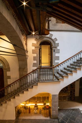 a staircase in an old building with a fireplace at Casa de la Luz Hotel Boutique in Mexico City