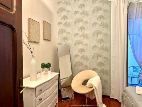 a bedroom with a vanity with a chair and a mirror at Charming light terraces near Basilica in Assisi in Santa Maria degli Angeli