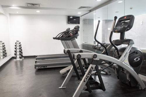 a gym with two tread machines in a room at Casa Inn Galerias Celaya in Celaya