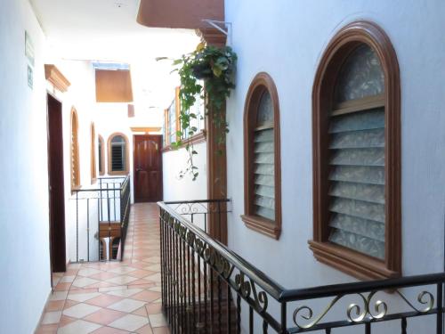 a hallway of a house with a balcony at Hotel Los Girasoles in Tepic
