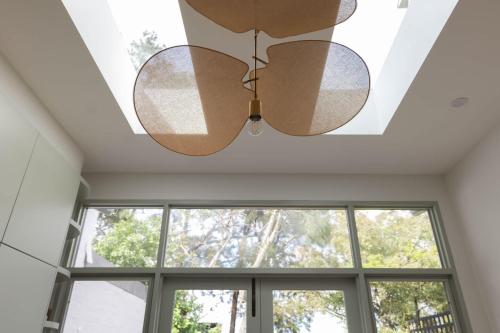 a ceiling fan in a room with windows at Exquisite Modern 3 Bed Home in Newtown w Parking in Sydney