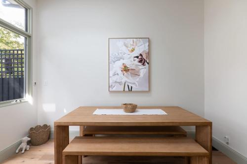 a wooden table in a room with a picture on the wall at Exquisite Modern 3 Bed Home in Newtown w Parking in Sydney
