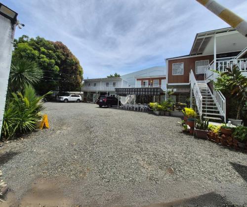 a gravel driveway in front of a house at Olive Hostel Roxas City in Roxas City