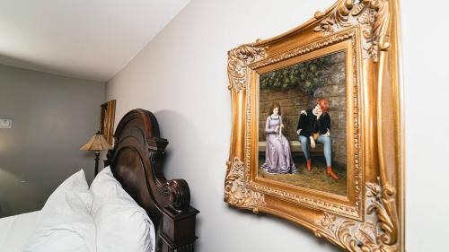a painting of a man and woman on a wall at Butter milk falls inn in Milton
