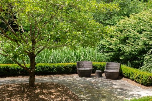 a park with a tree and three trash cans at Butter milk falls inn in Milton