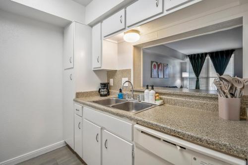 a kitchen with a sink and a counter top at Towne Plaza Apartments 111 - 7 km from FIFA Fest in Houston