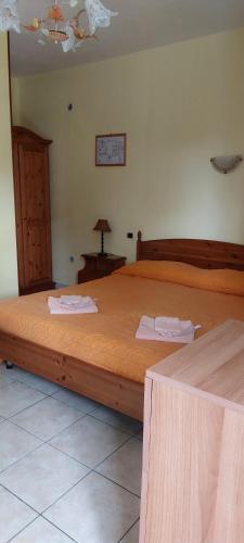 a bedroom with a large wooden bed in a room at Agri Grotta dell'Eremita in Castelmezzano