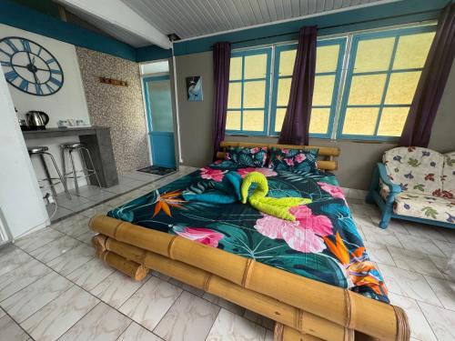 a bedroom with a bed with a stuffed animal on it at Blue Moana Lodge in Papara