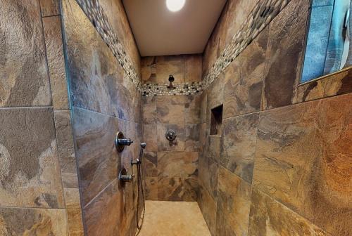 a large bathroom with a stone wall at Sunsets At Joe's in St. George Island