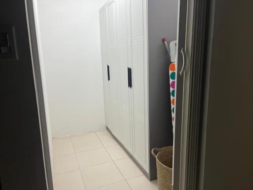 a room with white cabinets and a door with a broom at Villa Fina Aruba in Palm-Eagle Beach