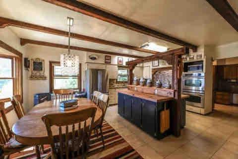 a kitchen and dining room with a table and chairs at Lake Hospitality LLC Woods Bay property on Flathead Lake in Bigfork MT with 2 homes in Bigfork
