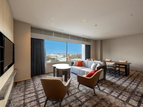 a living room with a couch and a table at ANA Crowne Plaza Akita by IHG in Akita