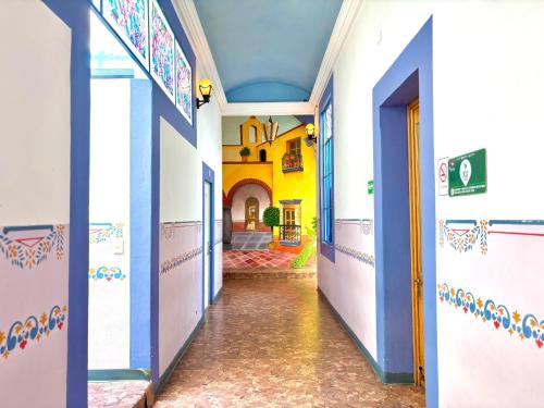 a hallway of a building with blue and white walls at Hotel La Alhondiga in Puebla