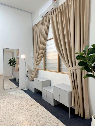 a room with a window with curtains and a mirror at W Home at Jalan Rangoon, George Town Penang in George Town