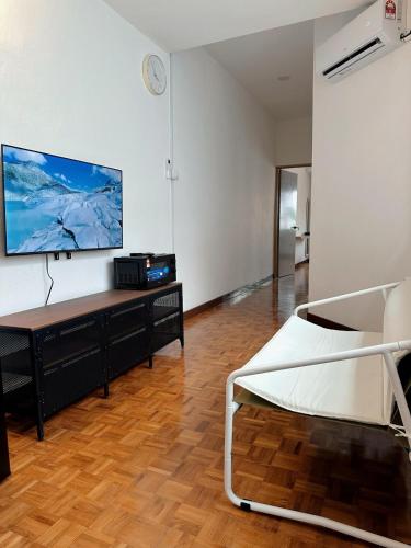 a living room with a tv on a wall at W Home at Jalan Rangoon, George Town Penang in George Town