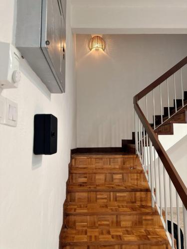 a staircase with wooden floors and a light on the wall at W Home at Jalan Rangoon, George Town Penang in George Town