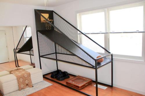 a black spiral staircase in a living room with a couch at Country House in Waterbury