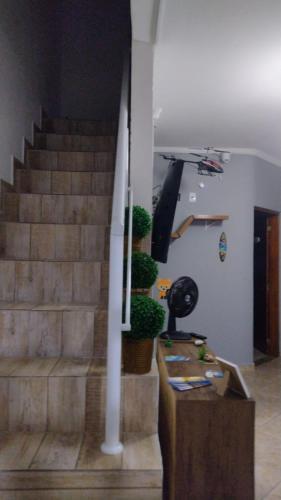 a staircase with potted plants and a helicopter at Hostel Canto da Alegria in Itanhaém