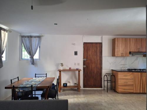 a kitchen and dining room with a table and a table and chairs at Departamento Chahué in Santa Cruz Huatulco