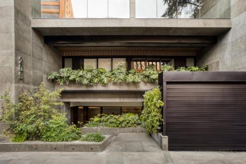 a building with plants on the side of it at UTOPIC Platon by ULIV in Mexico City