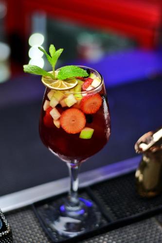 a drink with fruit and a mint on top of it at Hotel Baluarte Cartagena Boutique in Cartagena de Indias
