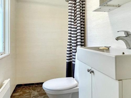 a bathroom with a toilet and a sink at 5 person holiday home in Mörlunda in Mörlunda