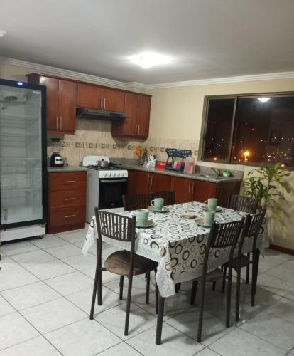 a kitchen with a table with chairs and a stove at Apartamento familiar in Cuenca