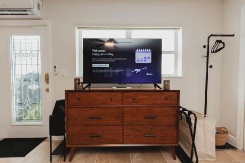 a television on top of a dresser in a living room at Cozy Miami Suite with FREE Parking in Miami