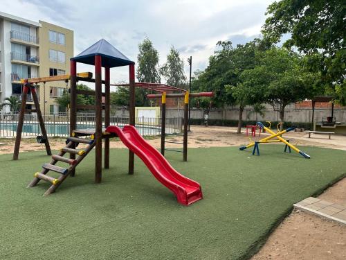 a playground with a slide and a slideintend at Apartamento Entresierras 3 hab con AC -un hogar lejos de casa in Valledupar