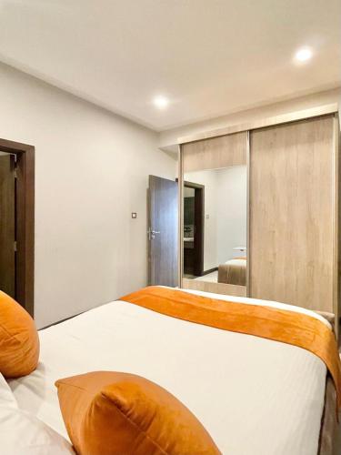 a bedroom with a bed and a large mirror at Skynest Residences Nairobi, Westlands in Nairobi