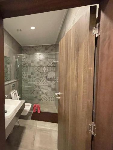 a bathroom with a shower and a toilet and a sink at Skynest Residences Nairobi, Westlands in Nairobi