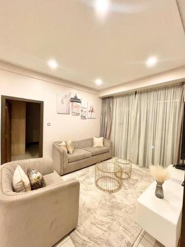 a living room with a couch and a table at Skynest Residences Nairobi, Westlands in Nairobi