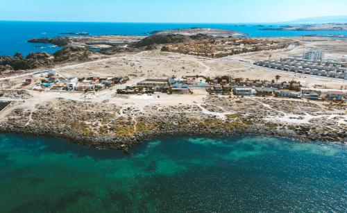 an aerial view of an island in the ocean at Aldea Bahiguana in Bahia Inglesa