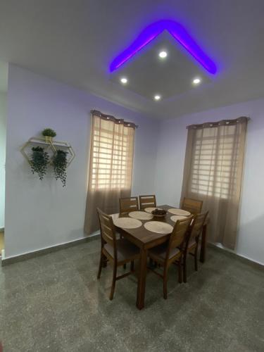 a dining room with a table and a purple ceiling at Relax San Juan in San Juan