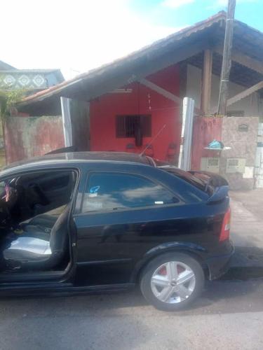 a black car parked in front of a gas station at Mongaguá, AGENOR de Campos, PRAIA in Mongaguá