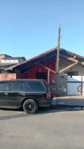 a black truck parked in front of a building at Mongaguá, AGENOR de Campos, PRAIA in Mongaguá