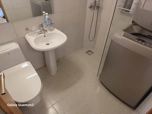 a bathroom with a toilet and a sink at Hongdae Guesthouse4 - 1min from Hongik Uni station Exit #1 in Seoul