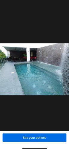 a picture of a swimming pool with a water fountain at Beachfront Condo Stunning Views in Jacó