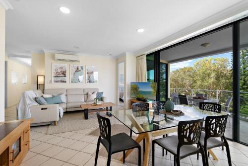 a living room with a table and chairs at Sea Breeze At Mudjimba Beachside, Tennis Pool in Mudjimba