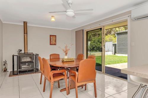 a kitchen and dining room with a table and chairs at Vinea Vista - Hillside Homestead amid Rural Beauty in Lenswood