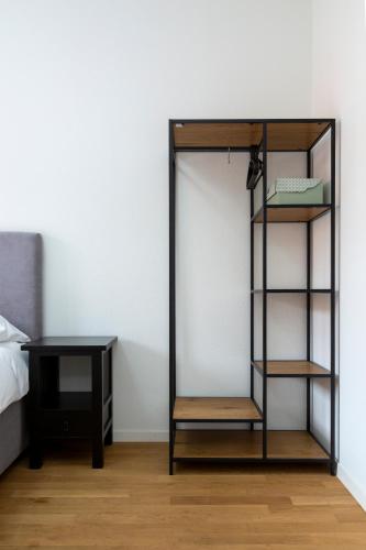 a bookcase next to a bed and a desk at KAYA Zurich Apartment 3B - Downtown 2BR Deluxe Apt in Zürich