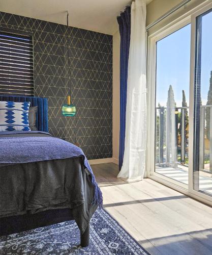 a bedroom with a bed and a large window at Forty First Place - Boutique Hostel in Los Angeles